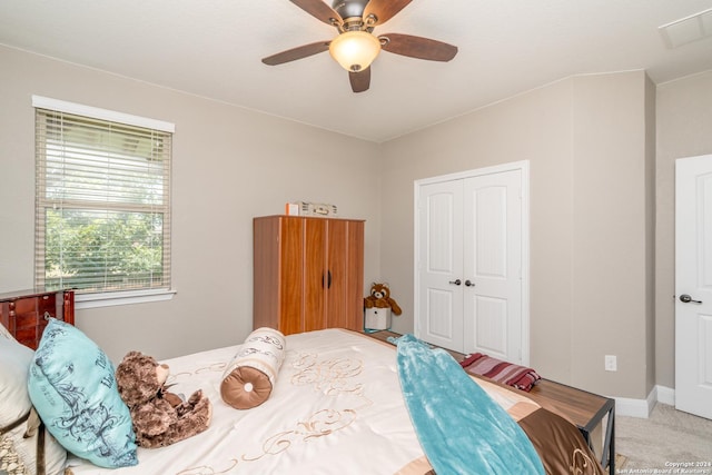 bedroom featuring carpet floors, a closet, visible vents, and a ceiling fan