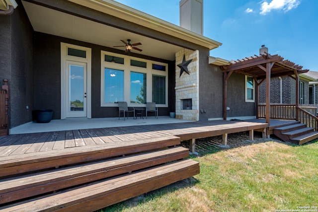 deck with a pergola, ceiling fan, and a yard