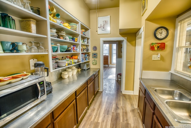 kitchen featuring a wealth of natural light, sink, and light hardwood / wood-style floors