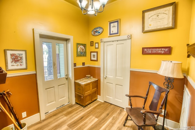 foyer entrance with light wood-type flooring and a chandelier