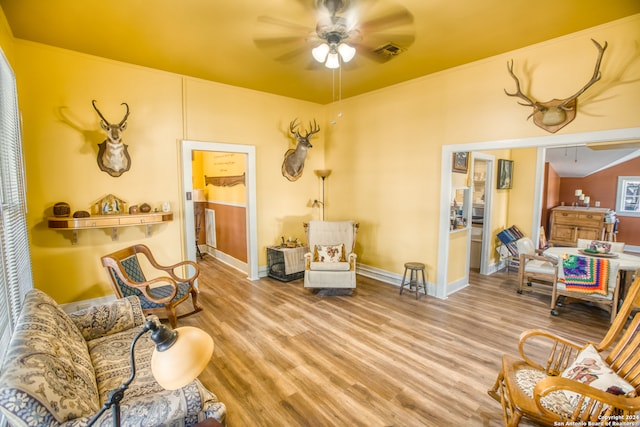 living room with ceiling fan and light hardwood / wood-style floors