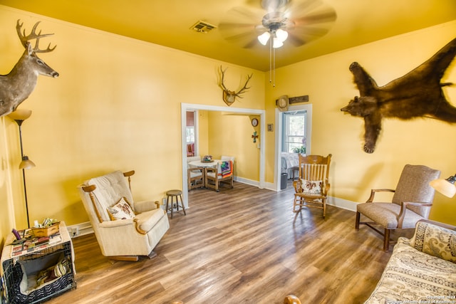 interior space with ceiling fan and wood-type flooring