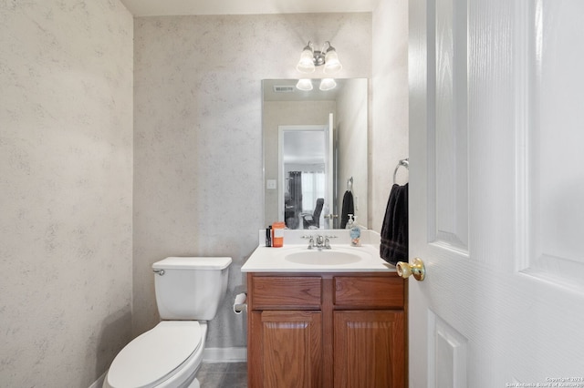 bathroom featuring toilet and vanity