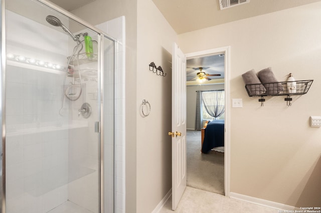 bathroom with ceiling fan, tile patterned flooring, and a shower with shower door