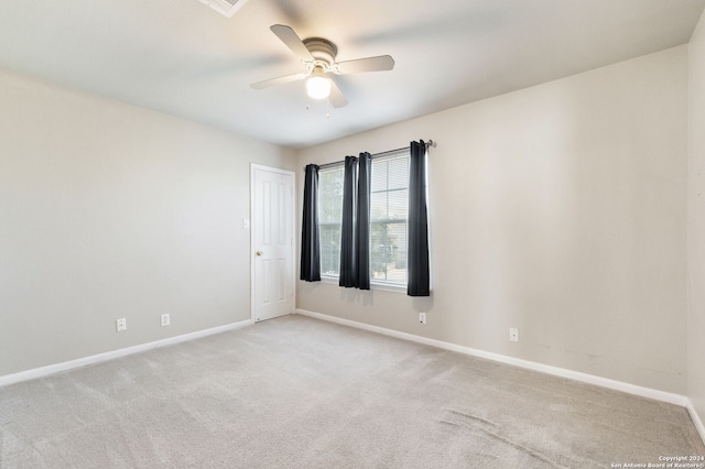 carpeted empty room featuring ceiling fan