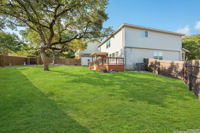 view of yard with central AC unit and a deck