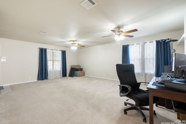 office space featuring ceiling fan and light colored carpet