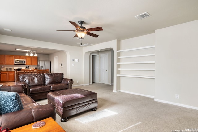 living room featuring ceiling fan and light carpet