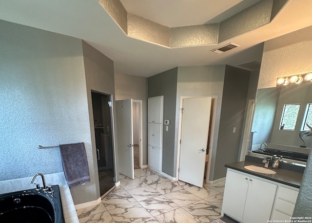 bathroom featuring tile patterned flooring, vanity, and separate shower and tub