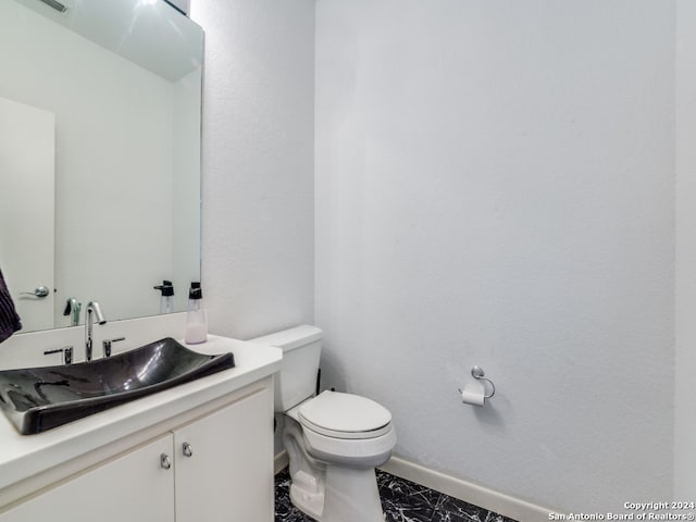 bathroom featuring vanity, toilet, and tile patterned flooring