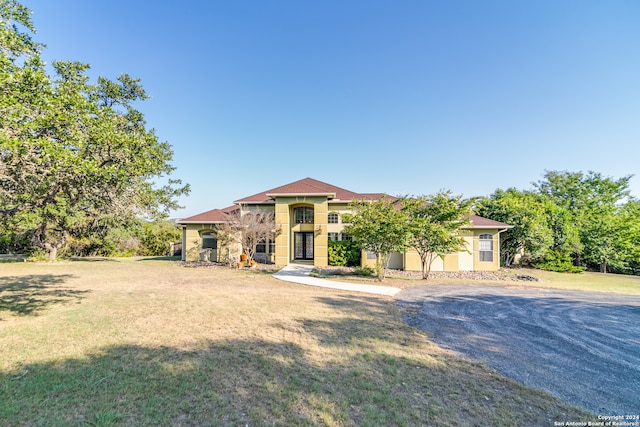 mediterranean / spanish home featuring a front yard