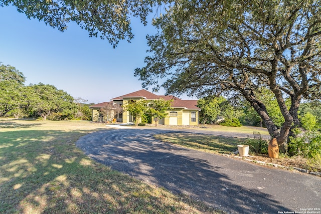 mediterranean / spanish home with a garage