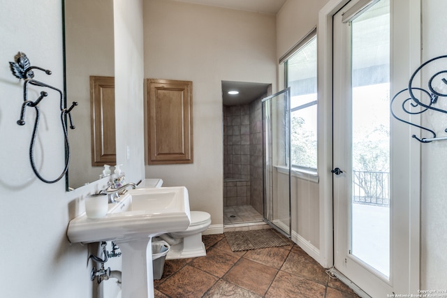 bathroom with toilet, walk in shower, and tile patterned floors