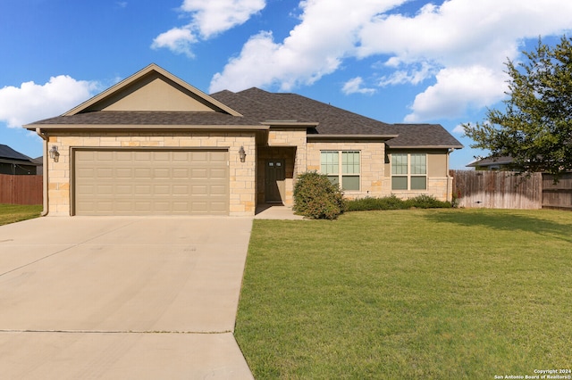 view of front of home with a garage and a front lawn