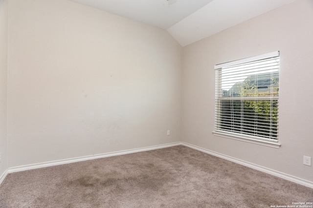 unfurnished room with carpet floors and lofted ceiling