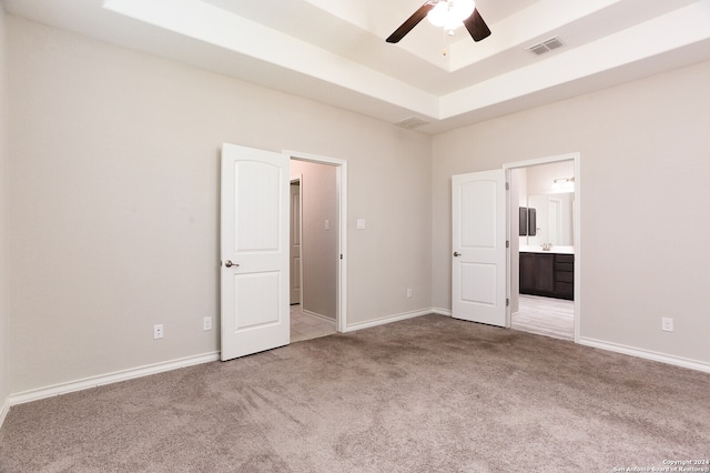 unfurnished bedroom featuring connected bathroom, ceiling fan, and carpet floors