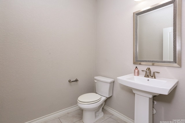 bathroom with toilet and tile patterned floors