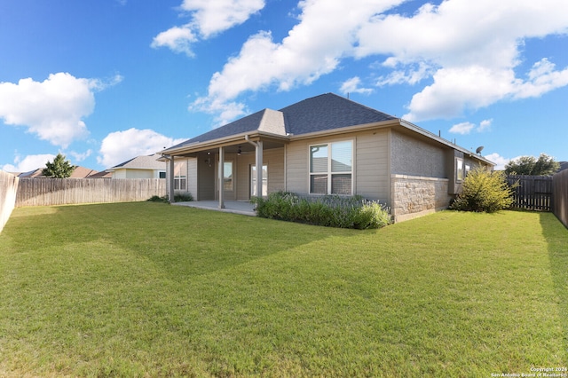 back of property with a patio and a yard