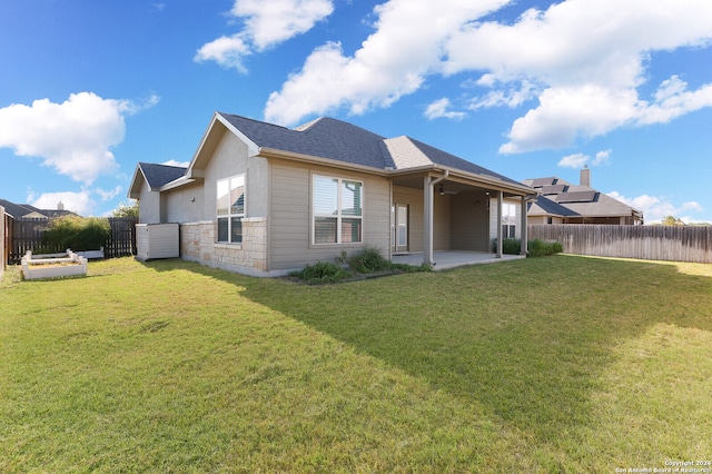 rear view of property featuring a lawn and a patio area