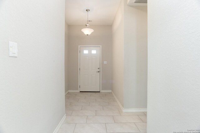 doorway featuring light tile patterned floors