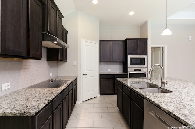 kitchen with light stone counters, light tile patterned floors, sink, stainless steel appliances, and decorative backsplash