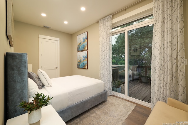 bedroom with access to outside and dark wood-type flooring