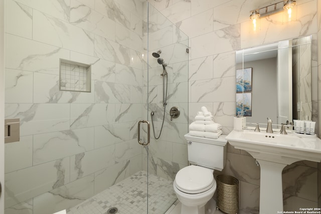 bathroom with an enclosed shower, toilet, and tile walls