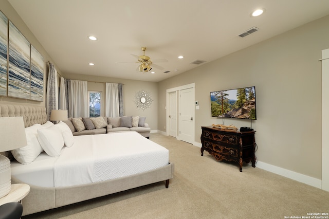 bedroom featuring ceiling fan and light carpet