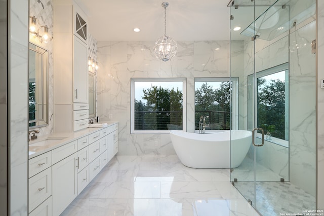 bathroom with tile walls, tile patterned floors, a healthy amount of sunlight, and vanity