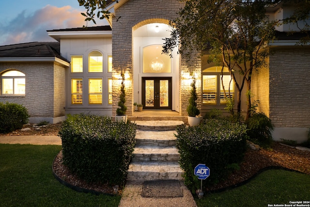 view of exterior entry at dusk