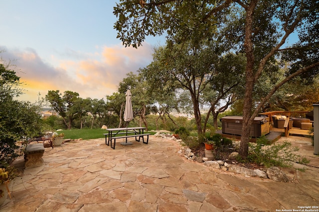 patio terrace at dusk with a hot tub