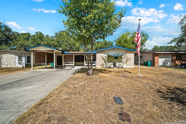 ranch-style house featuring a garage and a carport