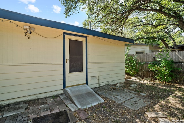 view of outbuilding featuring fence