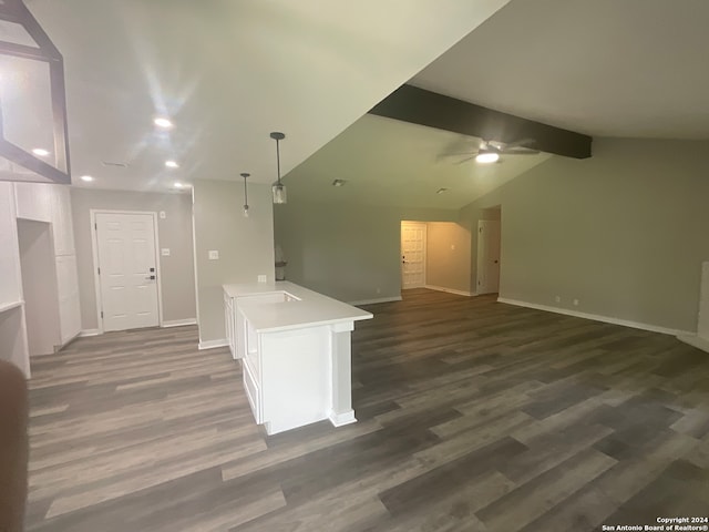 kitchen with ceiling fan, dark wood-type flooring, vaulted ceiling with beams, kitchen peninsula, and decorative light fixtures