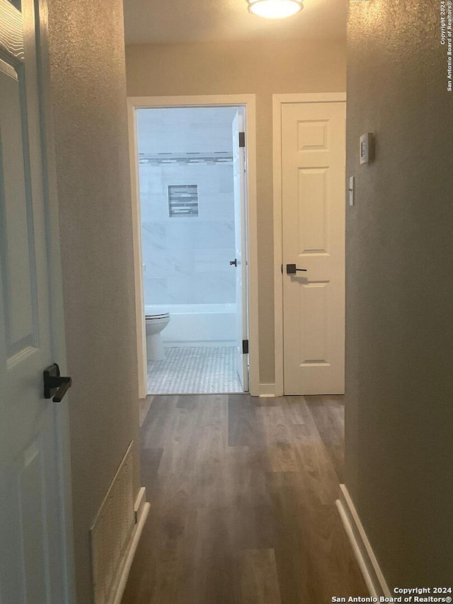 corridor featuring dark hardwood / wood-style floors