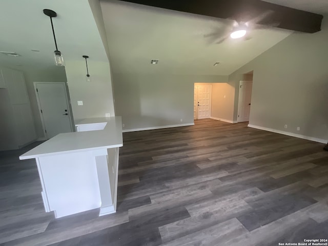 unfurnished living room featuring vaulted ceiling with beams and dark hardwood / wood-style floors