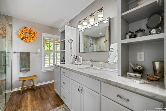 735 Hot Shot Ln, Mcqueeney, TX 78123 - bathroom featuring vanity, tiled shower, wood finished floors, and baseboards