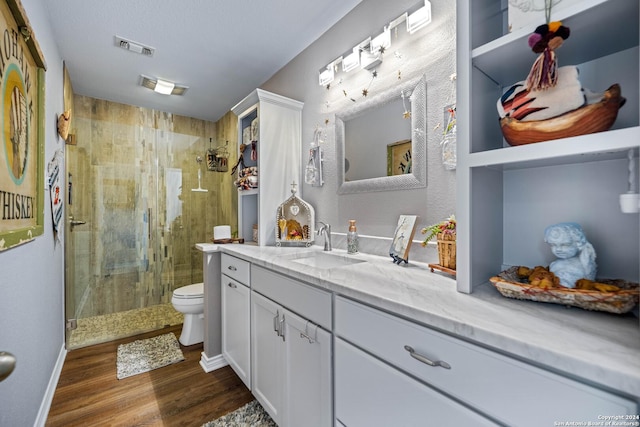 735 Hot Shot Ln, Mcqueeney, TX 78123 - bathroom with toilet, vanity, a shower stall, and wood finished floors