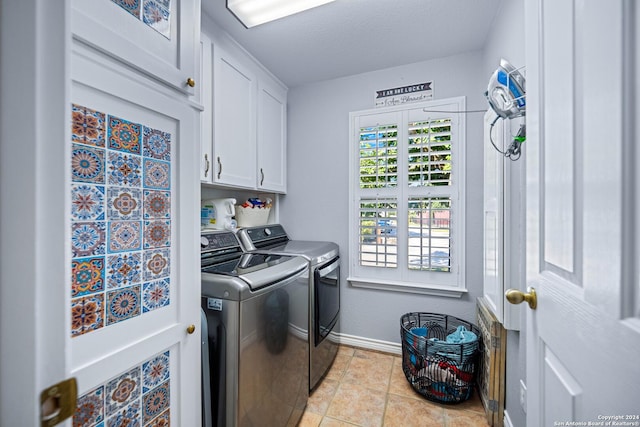 735 Hot Shot Ln, Mcqueeney, TX 78123 - clothes washing area with light tile patterned flooring, baseboards, cabinet space, and washing machine and dryer