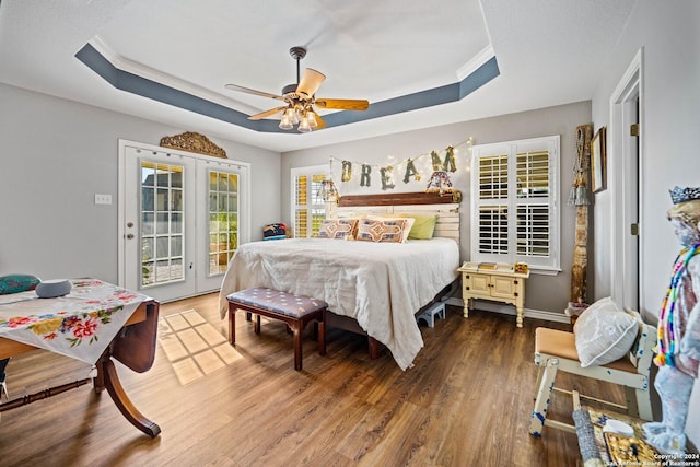 735 Hot Shot Ln, Mcqueeney, TX 78123 - bedroom with access to exterior, french doors, wood finished floors, and a tray ceiling