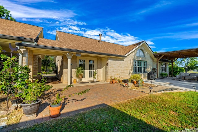 735 Hot Shot Ln, Mcqueeney, TX 78123 - back of house featuring french doors, roof with shingles, a patio, and stone siding