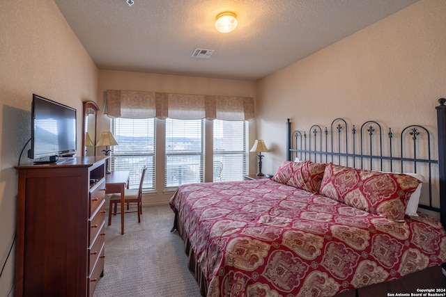 carpeted bedroom featuring a textured ceiling