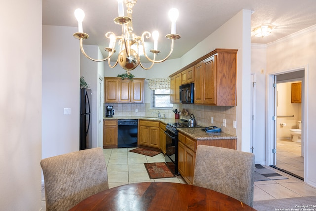 kitchen featuring backsplash, light tile patterned floors, black appliances, and sink