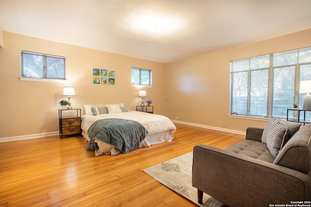 bedroom featuring baseboards and light wood finished floors