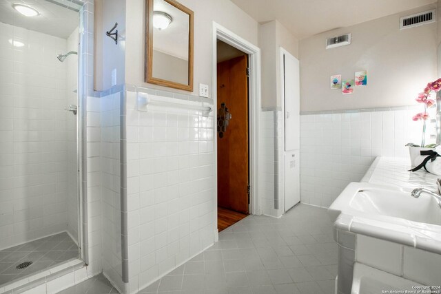 bedroom featuring connected bathroom and light wood-type flooring