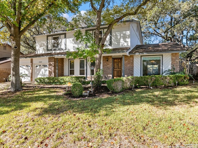 view of front of house with a front yard and a garage