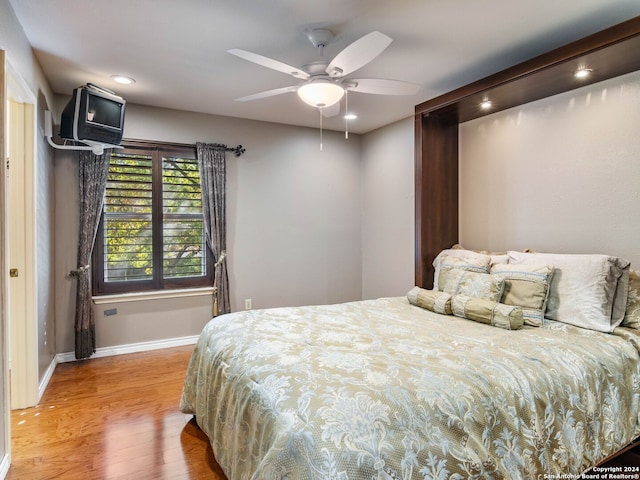 bedroom with ceiling fan and wood-type flooring