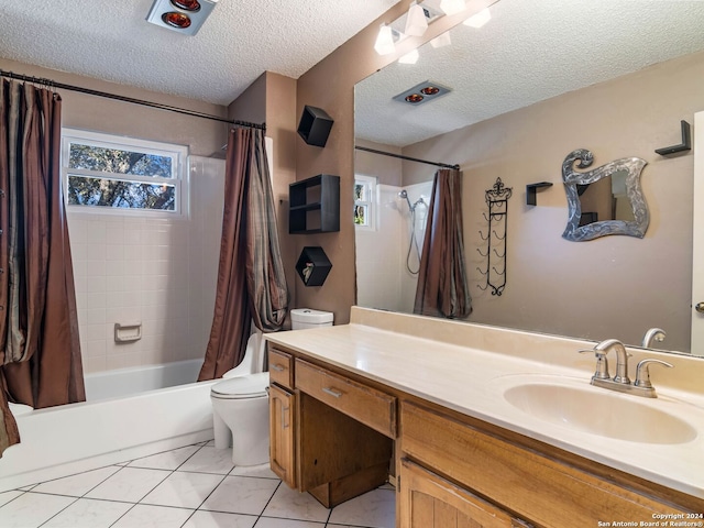 full bathroom featuring tile patterned flooring, a textured ceiling, toilet, shower / tub combo with curtain, and vanity