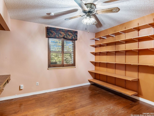 interior space with hardwood / wood-style flooring, ceiling fan, and a textured ceiling