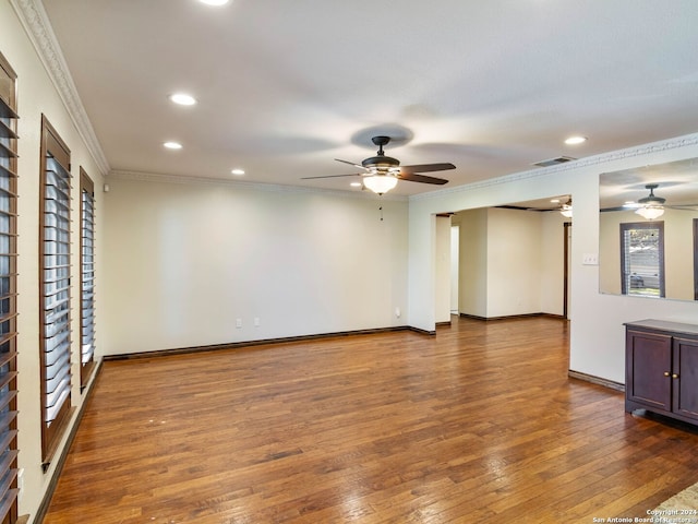 unfurnished living room with dark hardwood / wood-style flooring, ceiling fan, and crown molding